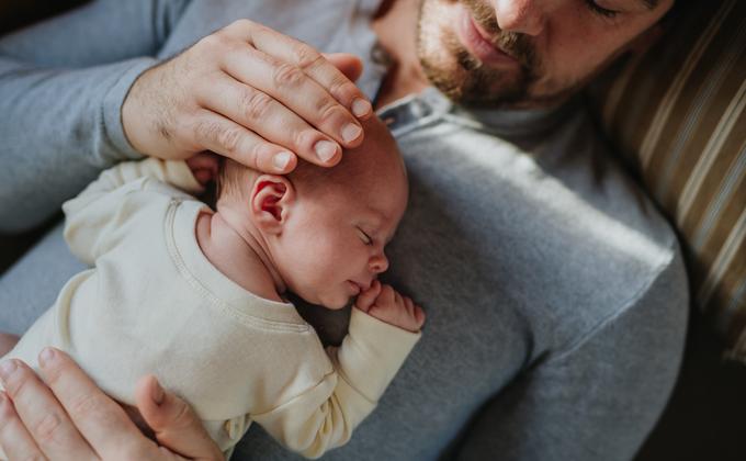 Close-up of father cudddling his little son.