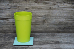 Green mug on wooden background
